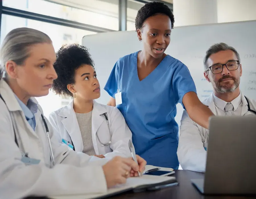 Healthcare team including RN and nurse practitioner discussing patient data